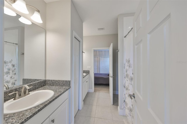 11909 Climbing Fern Ave, Riverview, FL 33579 - ensuite bathroom with connected bathroom, tile patterned floors, vanity, baseboards, and visible vents