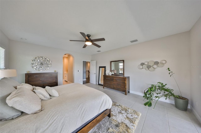 11909 Climbing Fern Ave, Riverview, FL 33579 - bedroom featuring light tile patterned floors, visible vents, ceiling fan, baseboards, and arched walkways