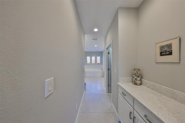 11909 Climbing Fern Ave, Riverview, FL 33579 - hallway with light tile patterned floors, recessed lighting, and visible vents