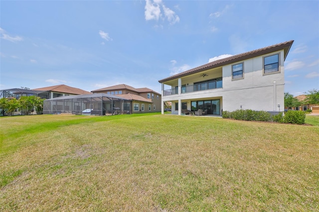 11909 Climbing Fern Ave, Riverview, FL 33579 - back of property featuring a ceiling fan, a yard, stucco siding, and a balcony