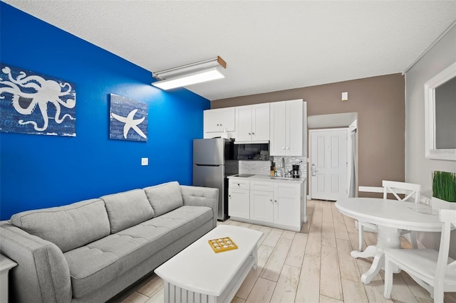 9980 Gulf Blvd Unit 603, Treasure Island, FL 33706 - living room with light wood-style floors