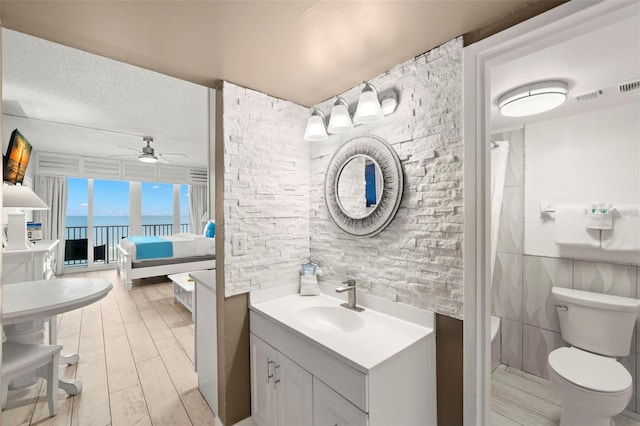 9980 Gulf Blvd Unit 603, Treasure Island, FL 33706 - bathroom featuring ceiling fan, tile walls, ensuite bathroom, wood finished floors, and a shower with curtain