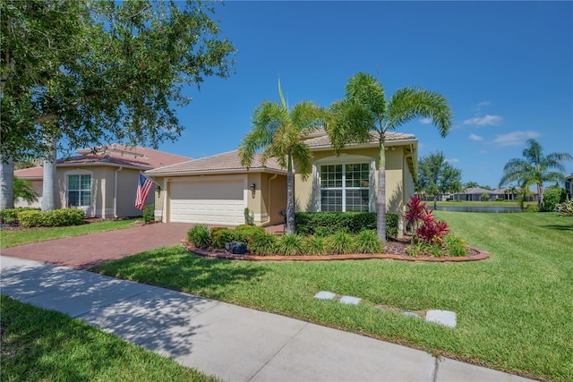 view of front of property with decorative driveway, an attached garage, a front yard, and stucco siding