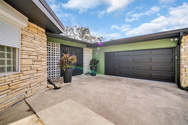 307 Orangewood Ln, Largo, FL 33770 - exterior space featuring an attached garage, driveway, and stone siding