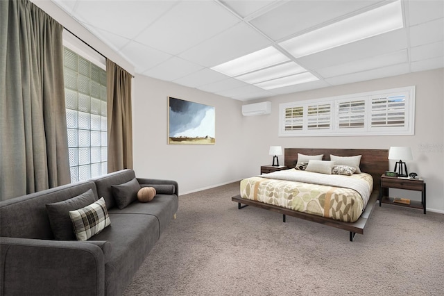 307 Orangewood Ln, Largo, FL 33770 - carpeted bedroom featuring baseboards, a drop ceiling, and a wall mounted air conditioner