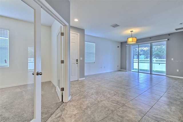 empty room featuring light tile patterned floors, baseboards, recessed lighting, and visible vents
