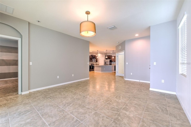 unfurnished room with light tile patterned flooring, baseboards, visible vents, and recessed lighting