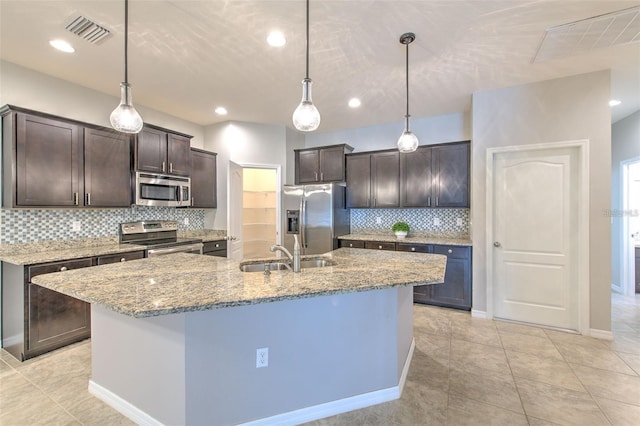 kitchen with visible vents, a sink, appliances with stainless steel finishes, and dark brown cabinets