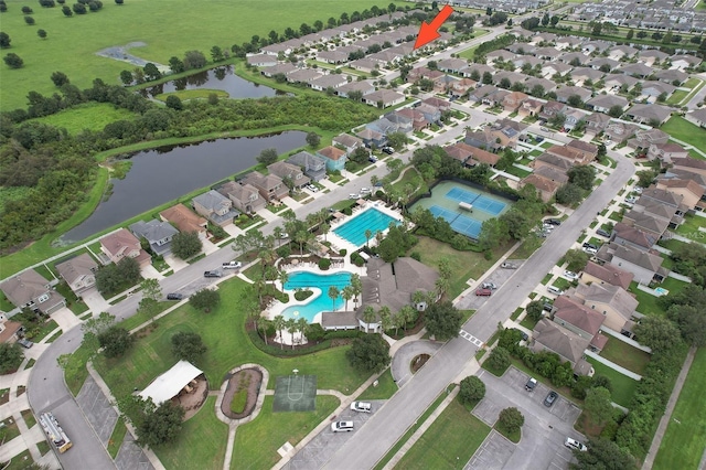 drone / aerial view with a water view and a residential view
