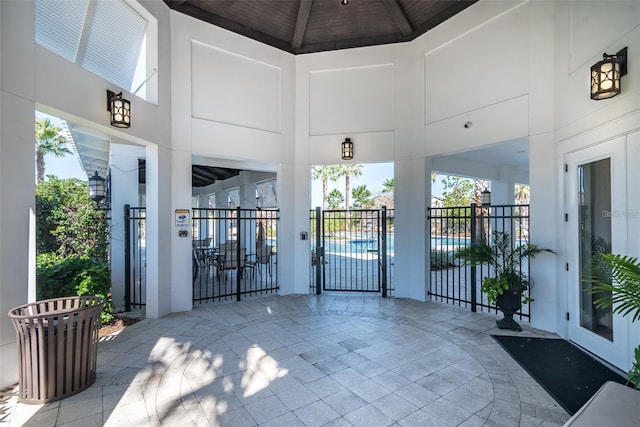 exterior space featuring fence and a community pool