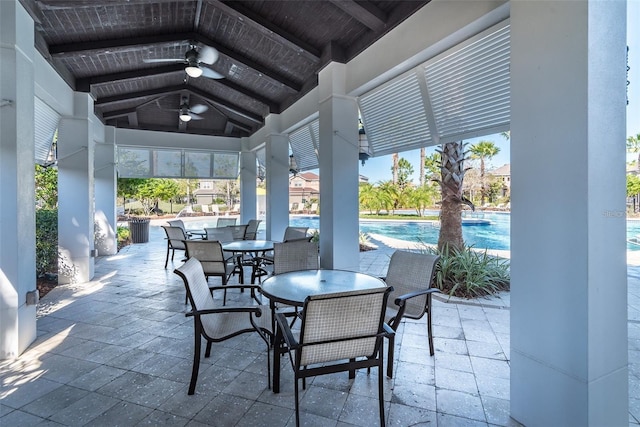 view of patio / terrace featuring ceiling fan, outdoor dining area, an outdoor pool, and a gazebo