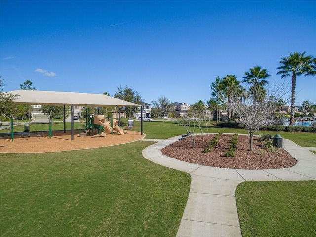 view of home's community with a lawn and playground community
