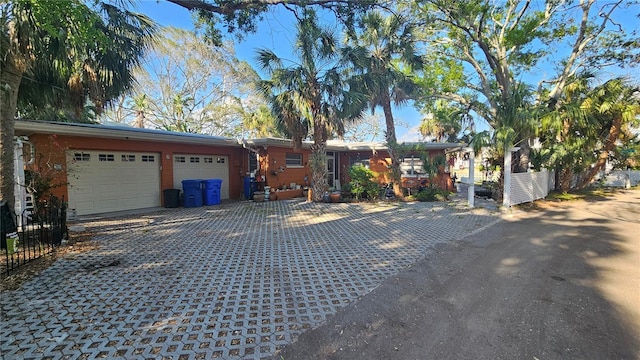 single story home with a garage and driveway