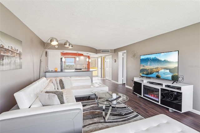 4725 Cove Cir Unit 604, Saint Petersburg, FL 33708 - living area with wood finished floors, baseboards, and a textured ceiling