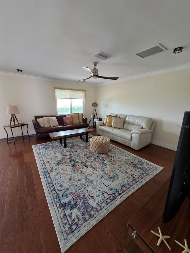 living room featuring crown molding, dark wood-style flooring, baseboards, and visible vents