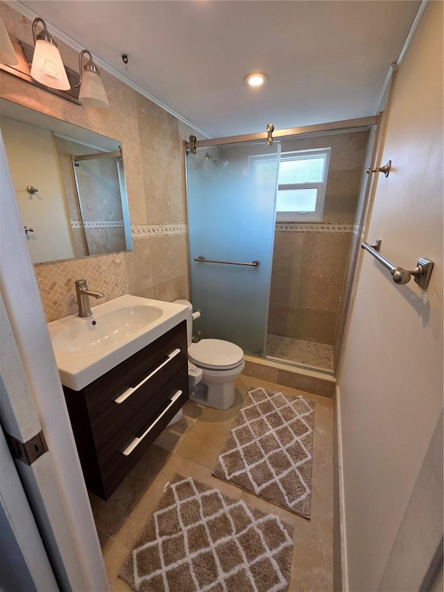 full bathroom with vanity, toilet, tile walls, ornamental molding, and a stall shower