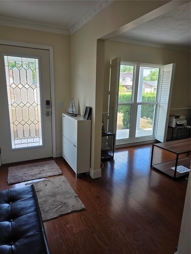 doorway to outside featuring crown molding, dark wood finished floors, and a wealth of natural light