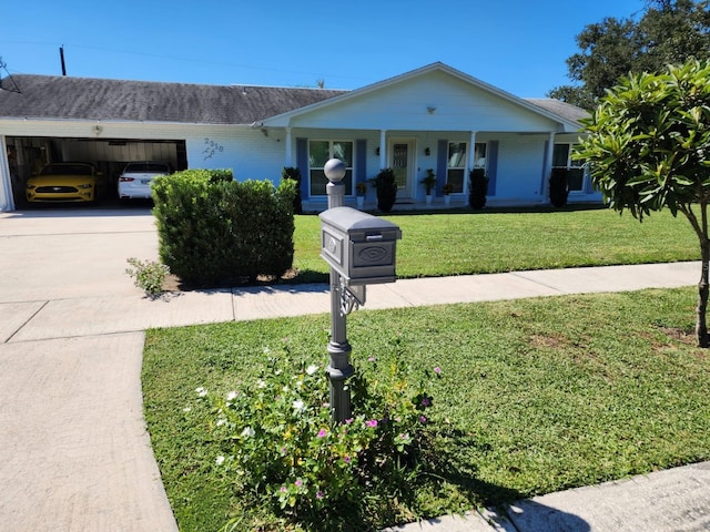 ranch-style house with concrete driveway, brick siding, a porch, and a front yard