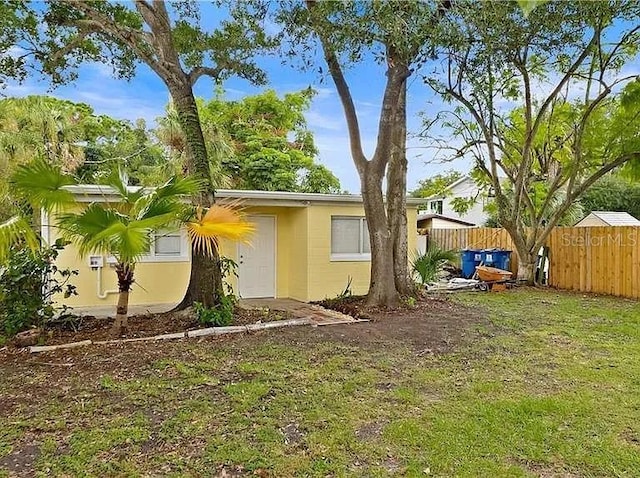 view of home's exterior featuring fence and a yard