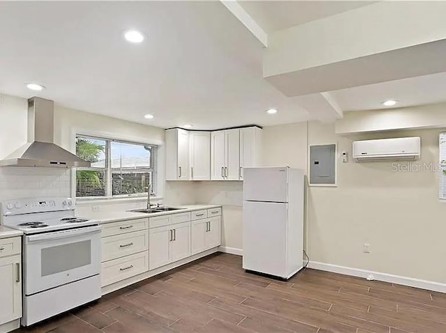 kitchen featuring wall chimney range hood, a sink, electric panel, an AC wall unit, and white appliances