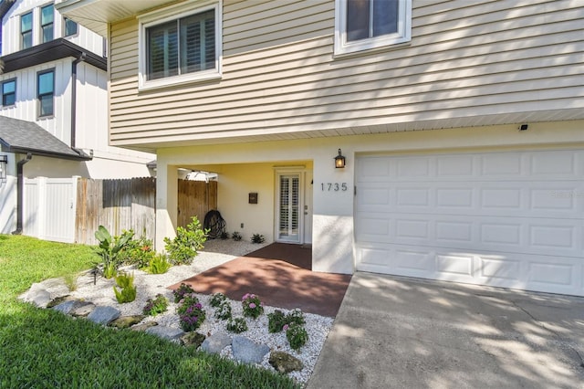 1735 Maryland Ave NE, Saint Petersburg, FL 33703 - view of exterior entry featuring fence and an attached garage