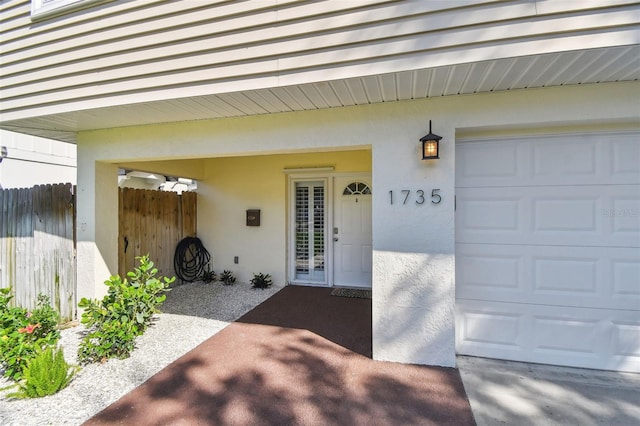 1735 Maryland Ave NE, Saint Petersburg, FL 33703 - view of exterior entry with stucco siding and fence