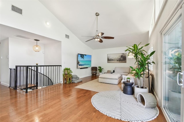 1735 Maryland Ave NE, Saint Petersburg, FL 33703 - living area with high vaulted ceiling, wood finished floors, ceiling fan, and baseboards