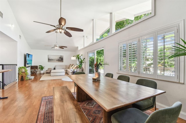 1735 Maryland Ave NE, Saint Petersburg, FL 33703 - dining room with high vaulted ceiling, light wood-style flooring, ceiling fan, and baseboards
