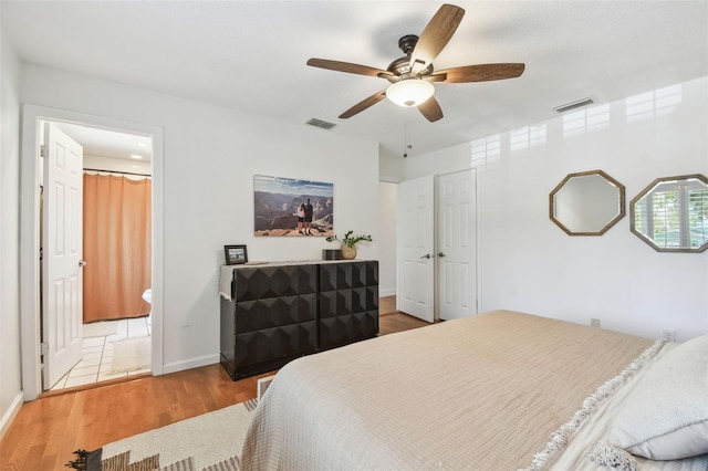 1735 Maryland Ave NE, Saint Petersburg, FL 33703 - bedroom with wood finished floors, baseboards, ceiling fan, and ensuite bath
