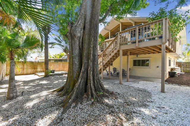 1735 Maryland Ave NE, Saint Petersburg, FL 33703 - back of house featuring a fenced backyard, a patio area, stucco siding, and a deck