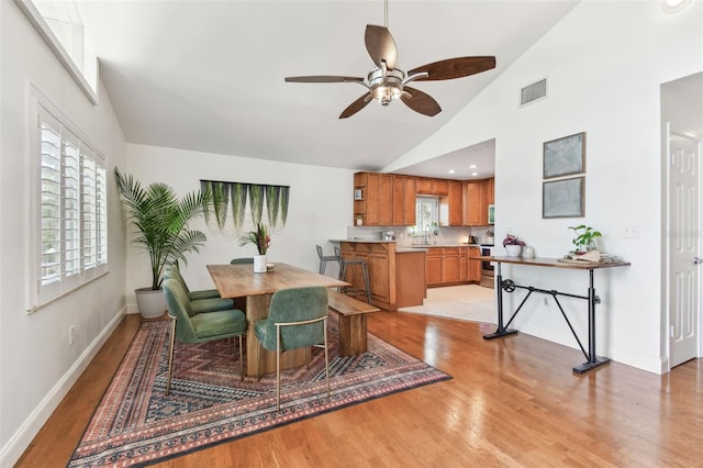 1735 Maryland Ave NE, Saint Petersburg, FL 33703 - dining area featuring lofted ceiling, light wood finished floors, ceiling fan, and baseboards
