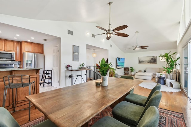 1735 Maryland Ave NE, Saint Petersburg, FL 33703 - dining space with light wood finished floors, ceiling fan, high vaulted ceiling, and recessed lighting