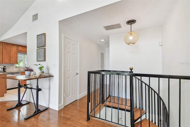 1735 Maryland Ave NE, Saint Petersburg, FL 33703 - hallway with an upstairs landing, light wood-type flooring, baseboards, and recessed lighting