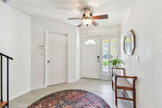 1735 Maryland Ave NE, Saint Petersburg, FL 33703 - entryway with a ceiling fan, light tile patterned floors, a textured wall, and baseboards