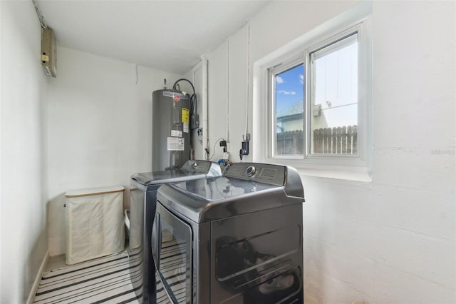 1735 Maryland Ave NE, Saint Petersburg, FL 33703 - clothes washing area with washing machine and dryer and water heater