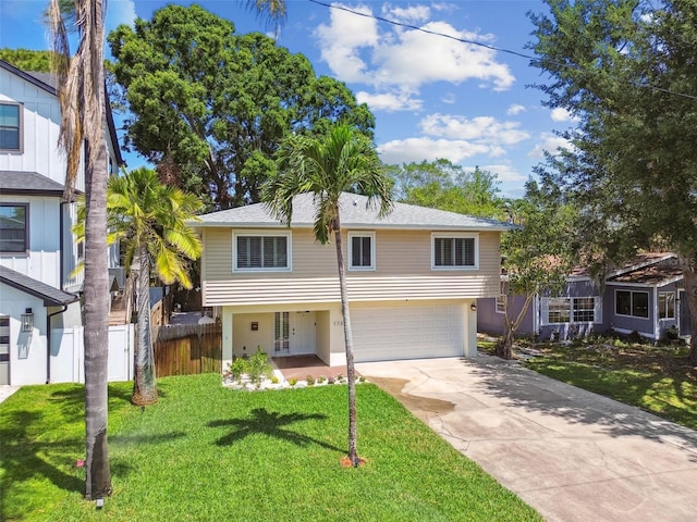 1735 Maryland Ave NE, Saint Petersburg, FL 33703 - view of front facade with driveway and a garage