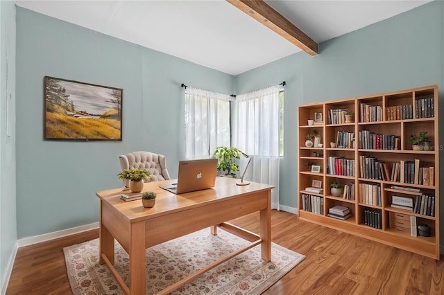 home office featuring baseboards, wood finished floors, and beamed ceiling