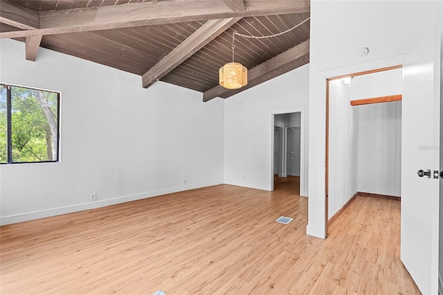 unfurnished bedroom featuring visible vents, wooden ceiling, baseboards, light wood-style floors, and vaulted ceiling with beams