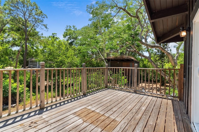 deck featuring a storage unit and an outbuilding
