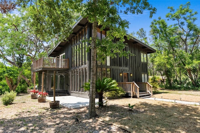 rear view of house featuring board and batten siding