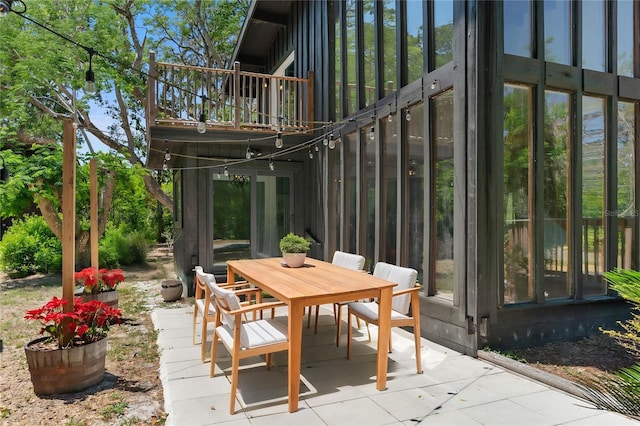 view of patio featuring outdoor dining space and a balcony
