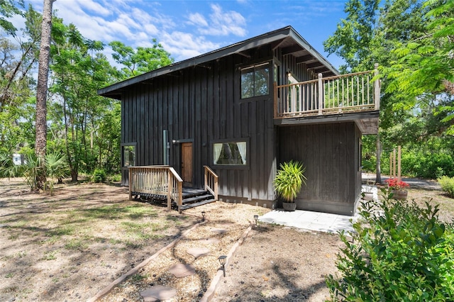 exterior space with a wooden deck and a balcony