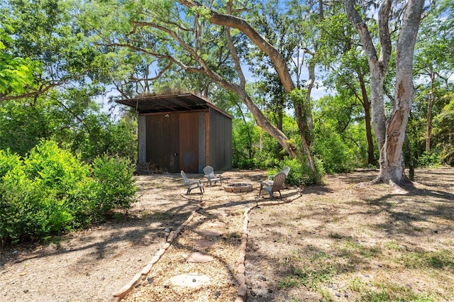 view of shed featuring an outdoor fire pit