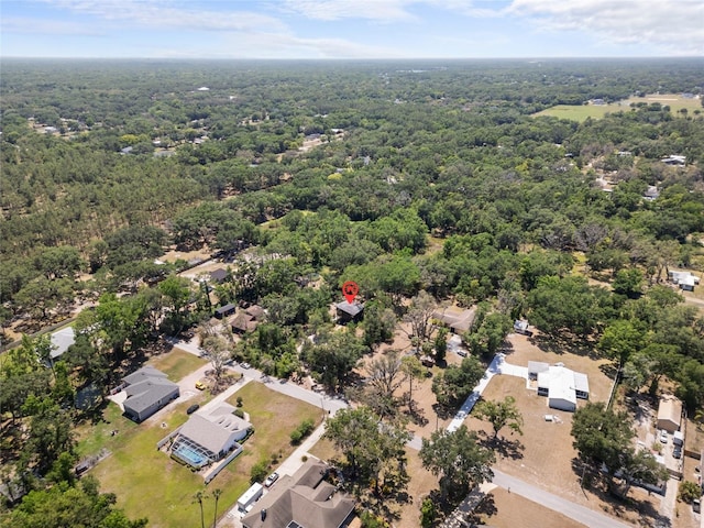 birds eye view of property featuring a forest view