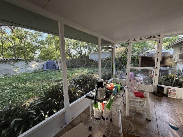 sunroom / solarium with stone tile floors