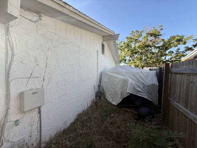 view of property exterior featuring fence