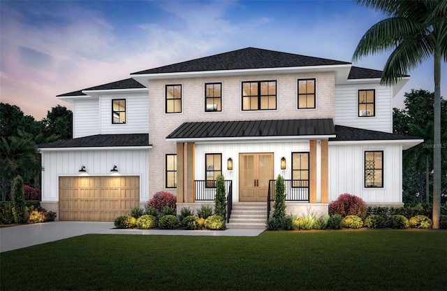 modern farmhouse style home featuring a front lawn, a garage, covered porch, driveway, and board and batten siding