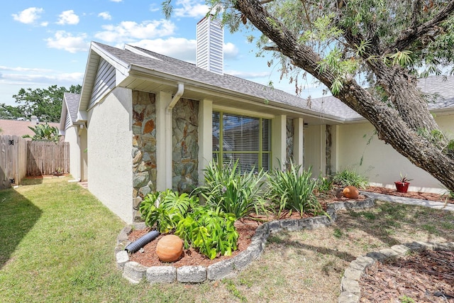 1227 Tuxford Dr, Brandon, FL 33511 - view of side of property with a chimney, roof with shingles, fence, stone siding, and stucco siding