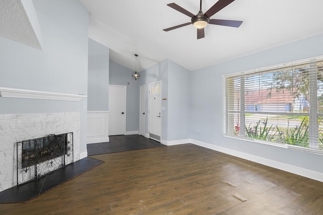 1227 Tuxford Dr, Brandon, FL 33511 - unfurnished living room with dark wood-type flooring, a ceiling fan, a fireplace with raised hearth, and high vaulted ceiling