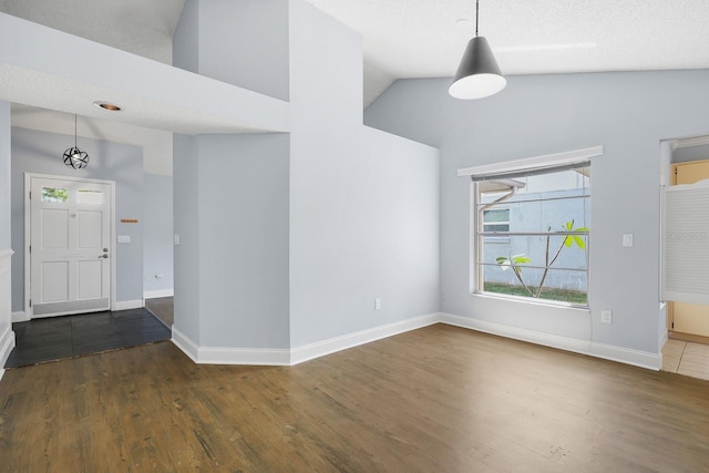 1227 Tuxford Dr, Brandon, FL 33511 - foyer featuring baseboards, wood finished floors, and high vaulted ceiling